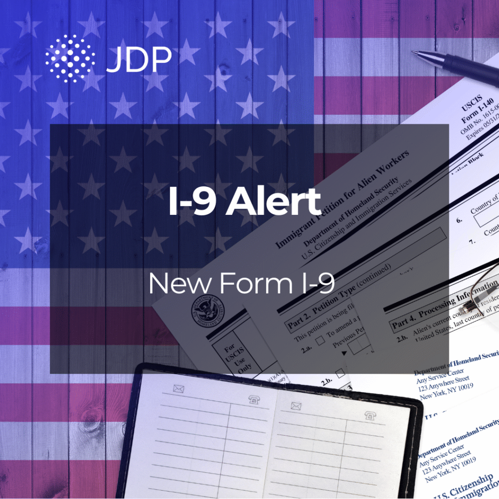 An American flag with Form I-9 paperwork on top of it.