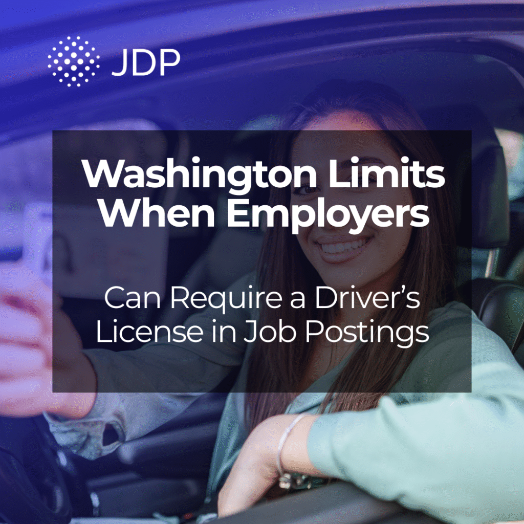 A female holding her driver's license inside her car.