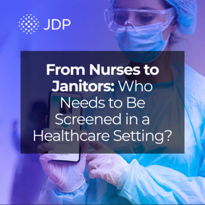 A nurse holding a verified background check on her phone.